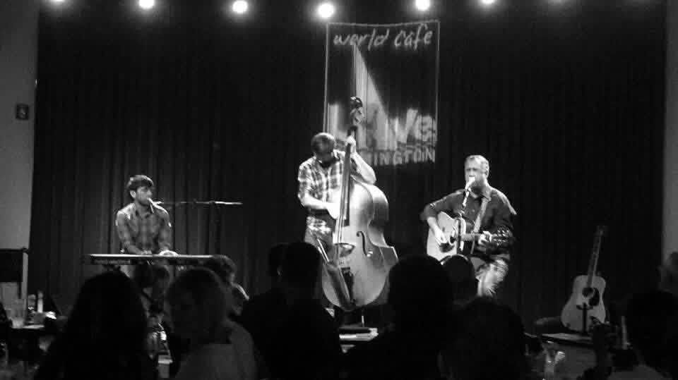 Trio on stage at World Cafe Live in Wilmington — keys, upright bass, and acoustic guitar